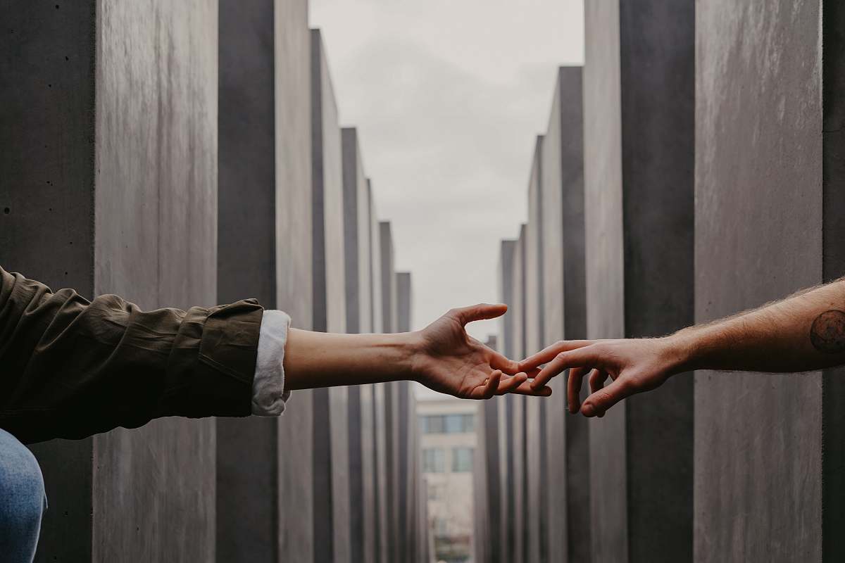 person two people reaching hands finger