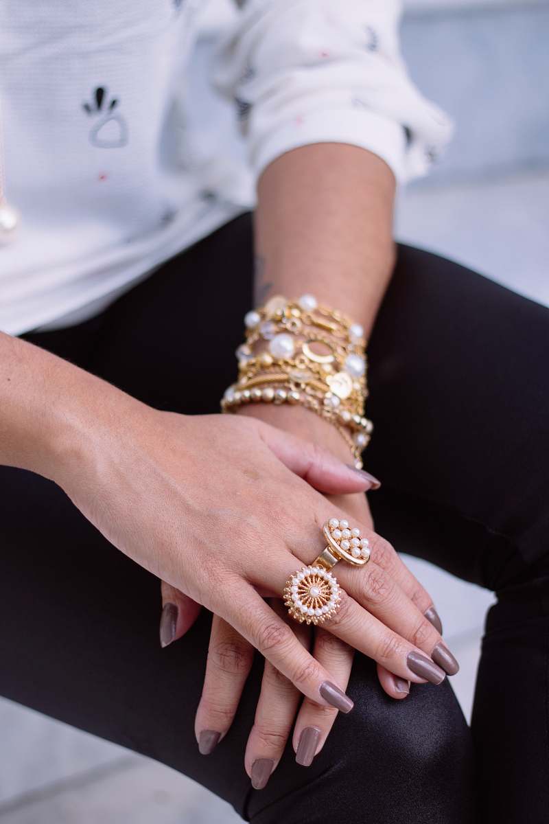 person two white pearl encrusted gold-colored rings people