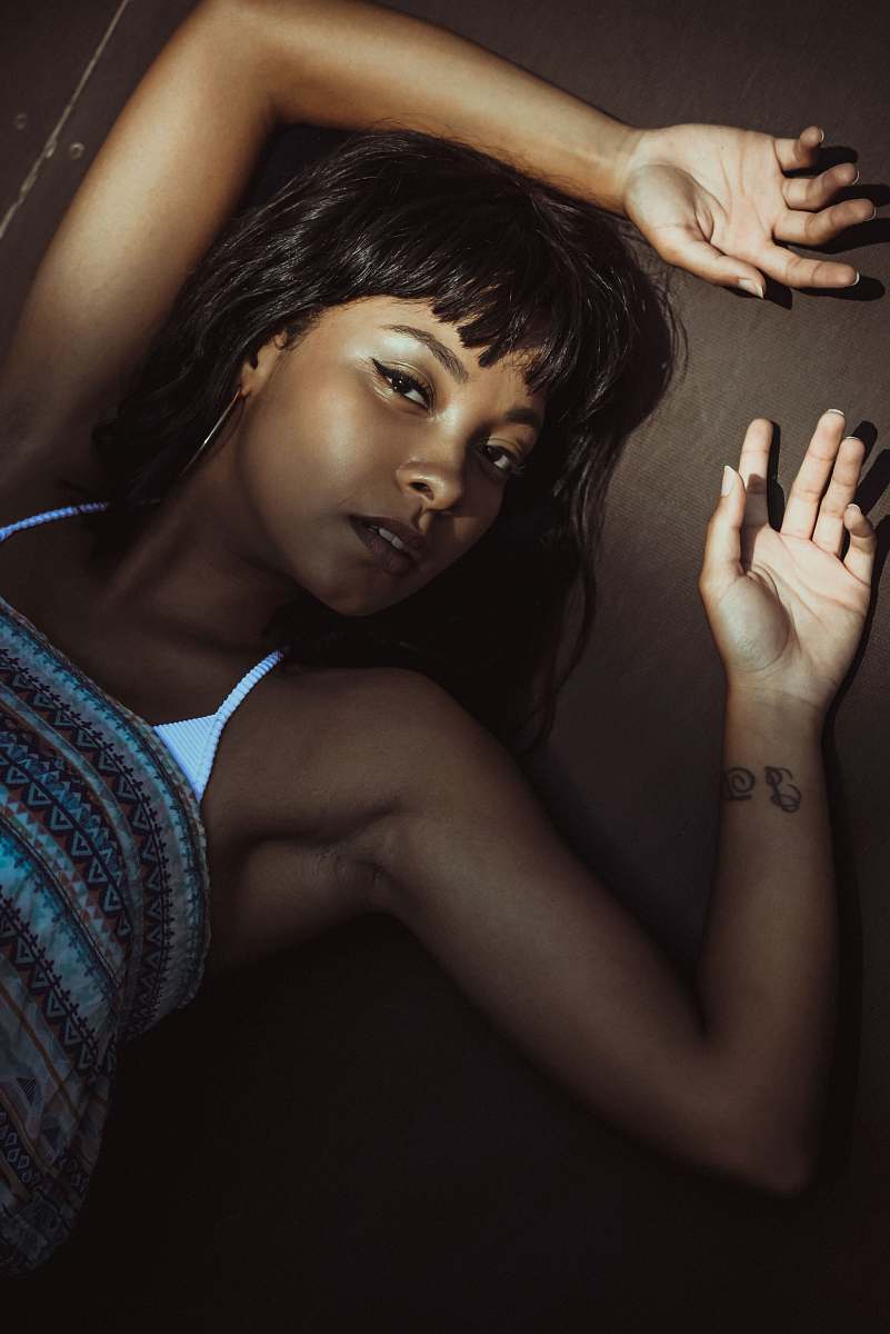 person woman lying while raising both hands hand