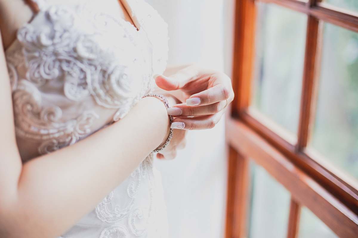 person woman touching her bracelet finger