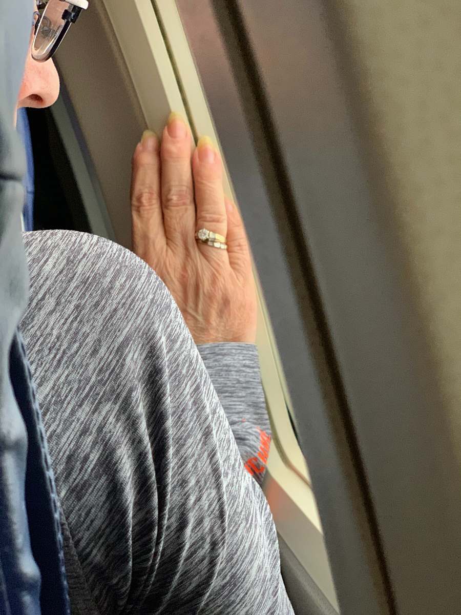 person woman wears gold-colored ring finger