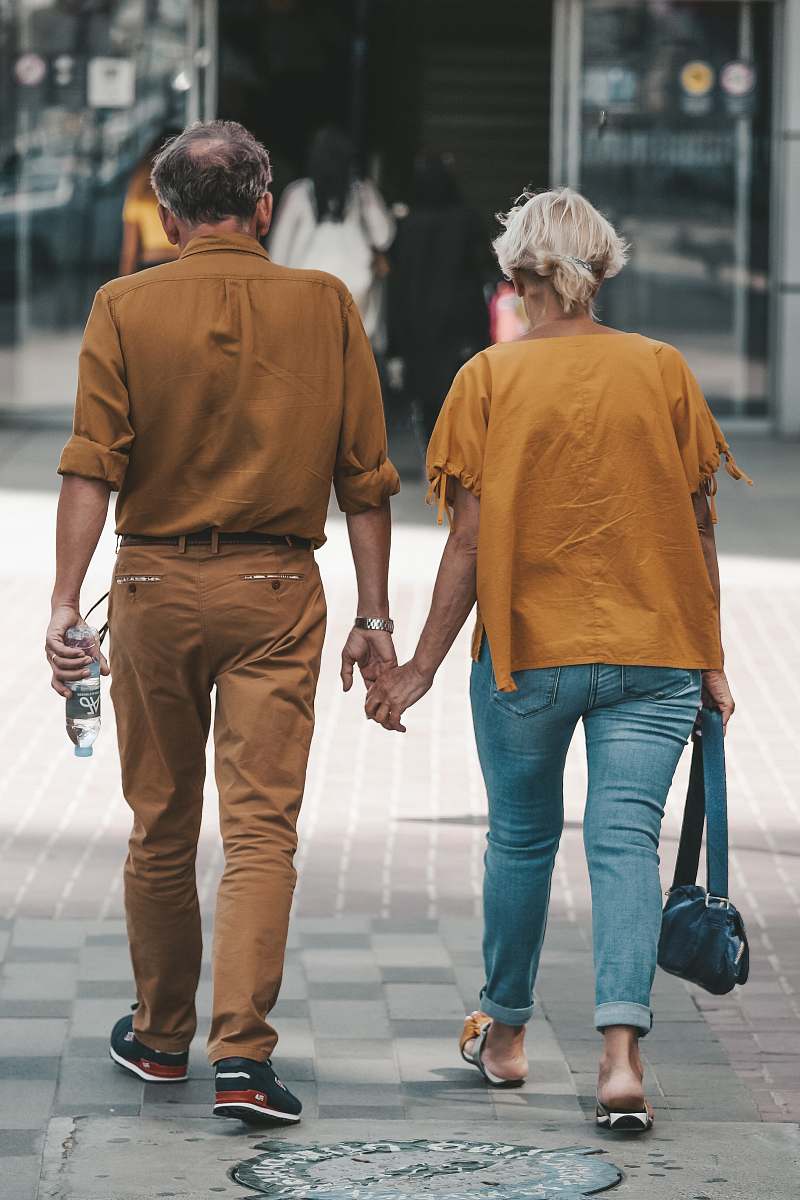 denim couple holding hands during daytime clothing