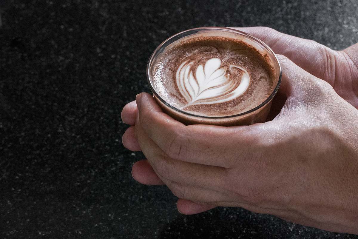 beverage person holding glass cup coffee cup