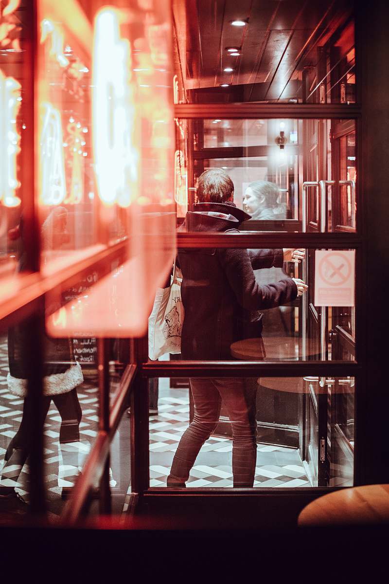 glass man standing near glass wall window