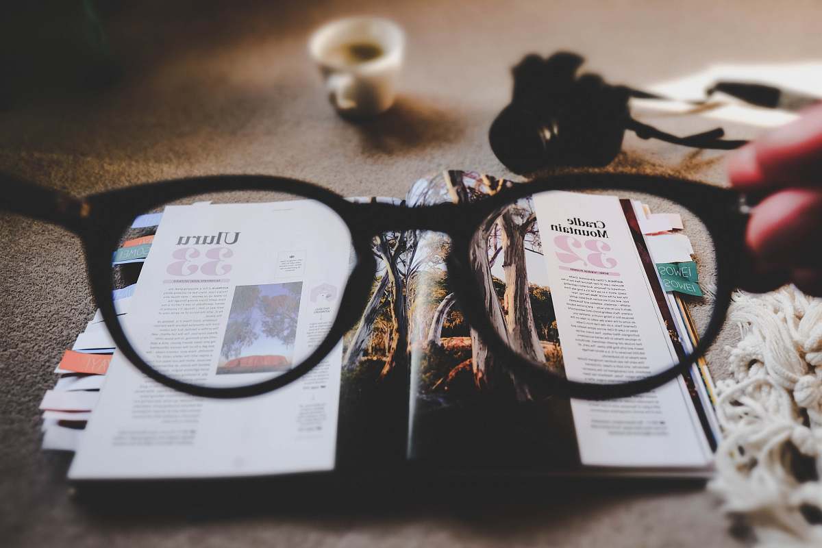 read eyeglasses with brown frames and open book spactacles