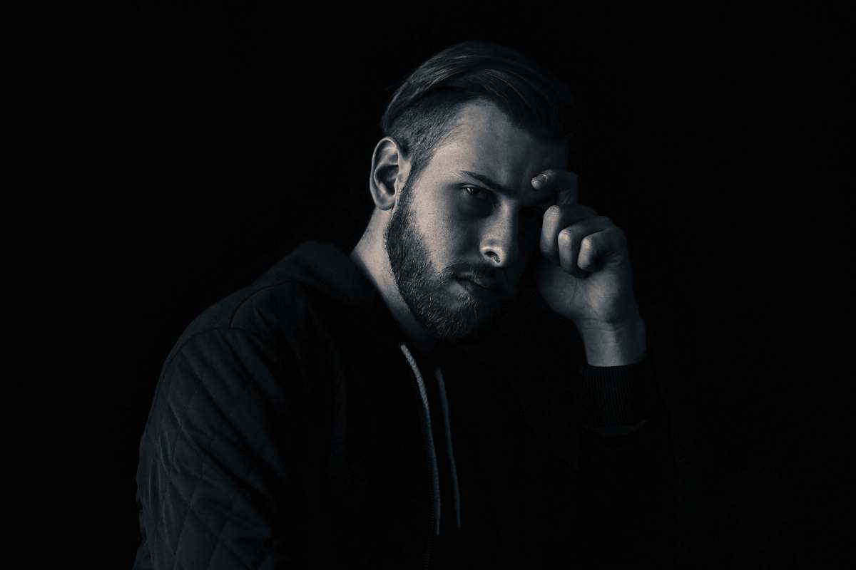 male man leaning his face on his right hand guy