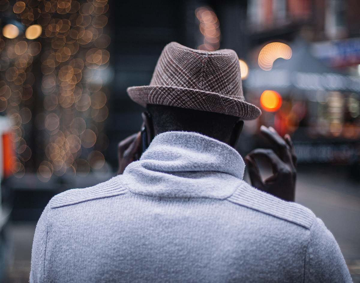 male person talking to phone raising his hand with ok sign back