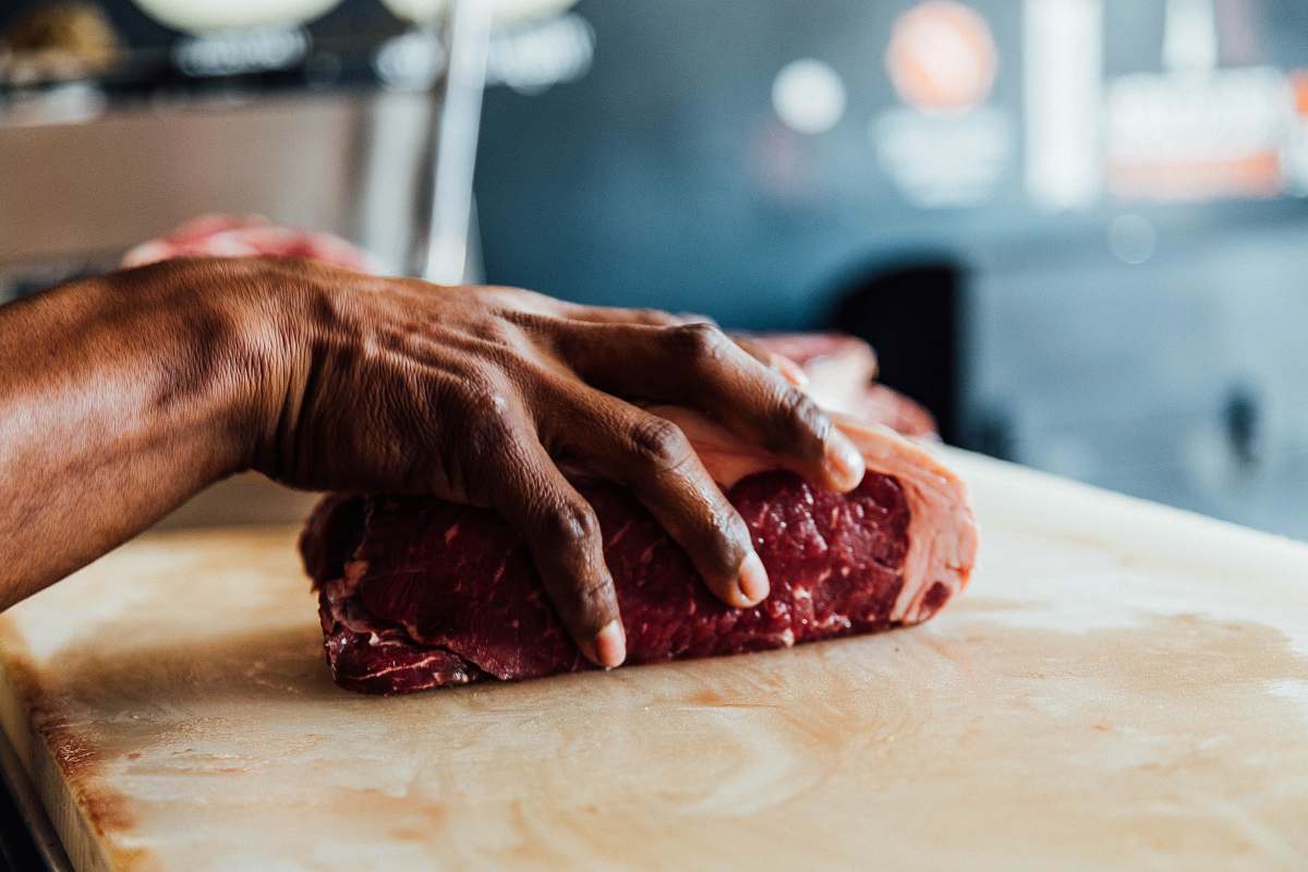 butcher A butcher holding a piece of meat in his hand in Boca del Río beef