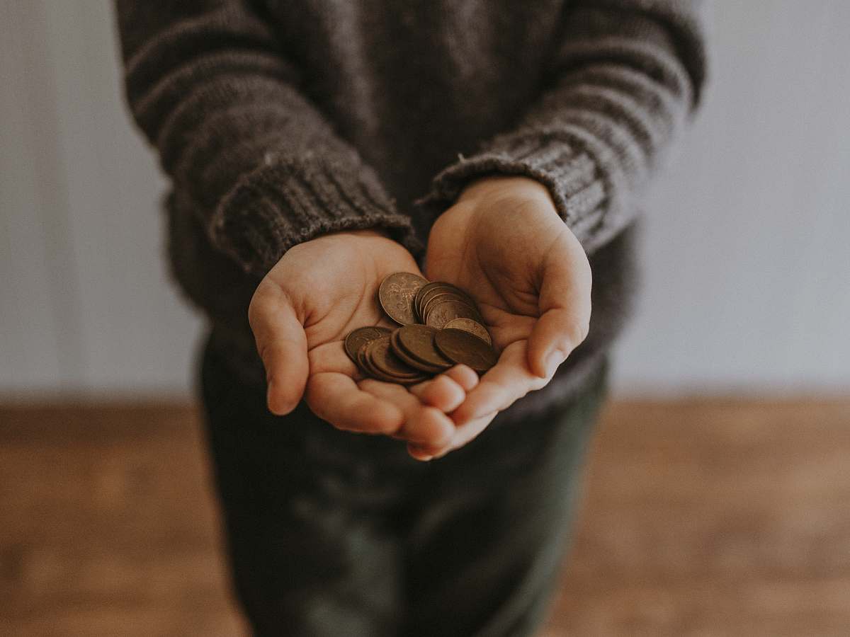 fund copper-colored coins on in person's hands change