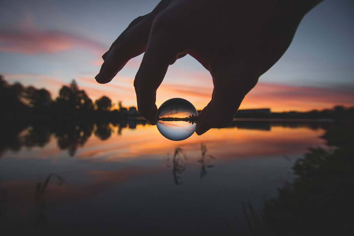 outdoors forced perspective photography of ball water water