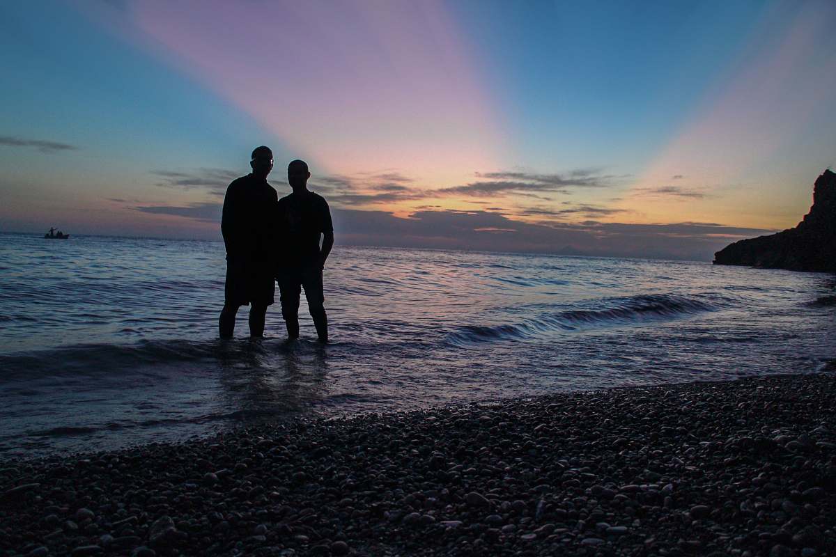 ocean silhoeutte of men on beach outdoors