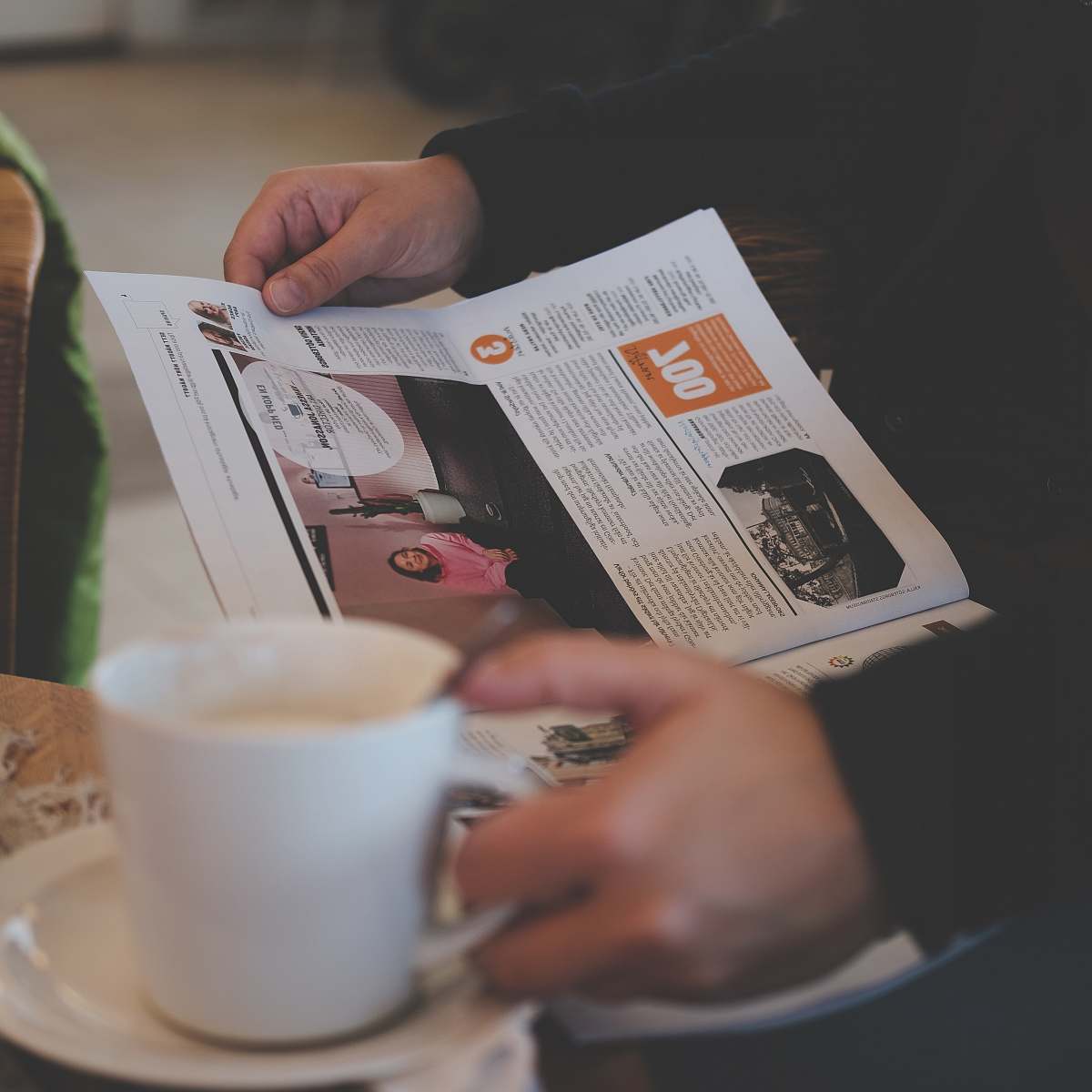 coffee person reading while holding white ceramic mug reading