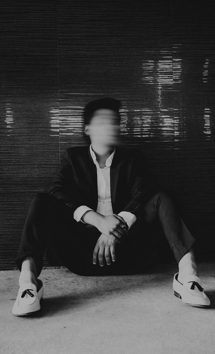 person man sitting on floor black-and-white