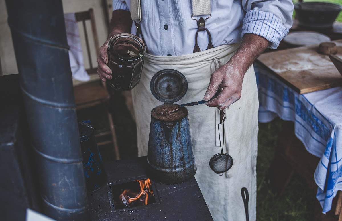 person man standing while holding can and jar man