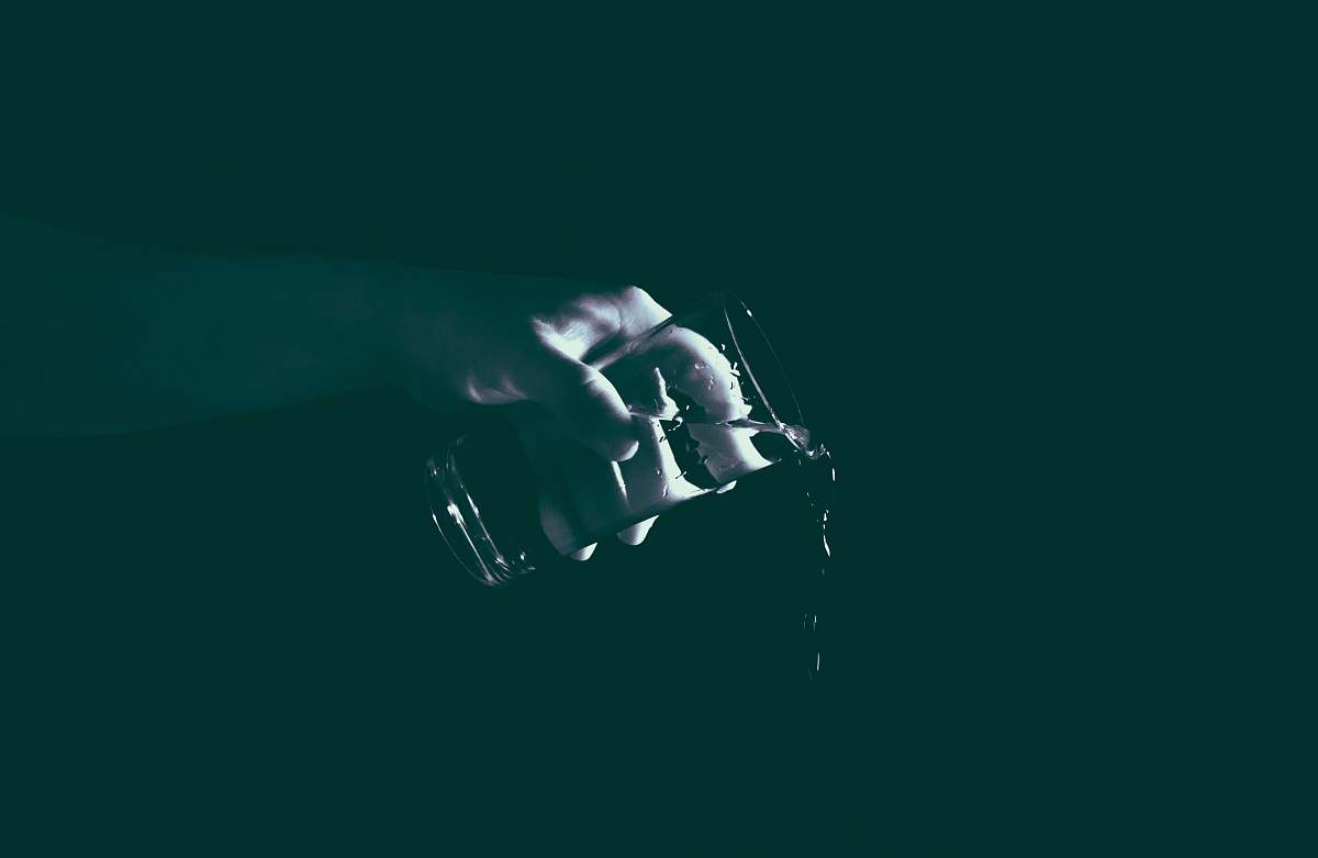 human person holding drinking glass with water person