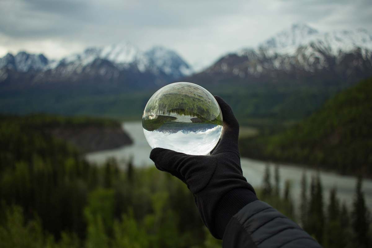 human person holding glass globe person