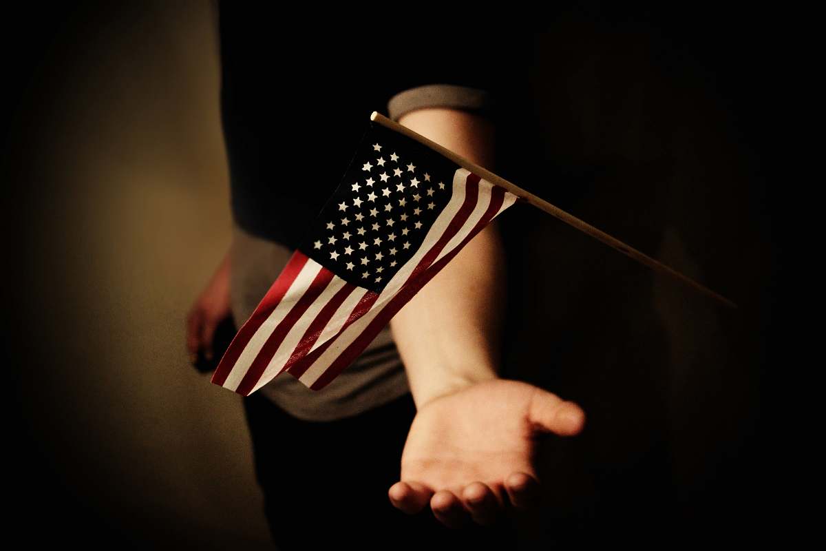 human person with open palms below USA flaglet person
