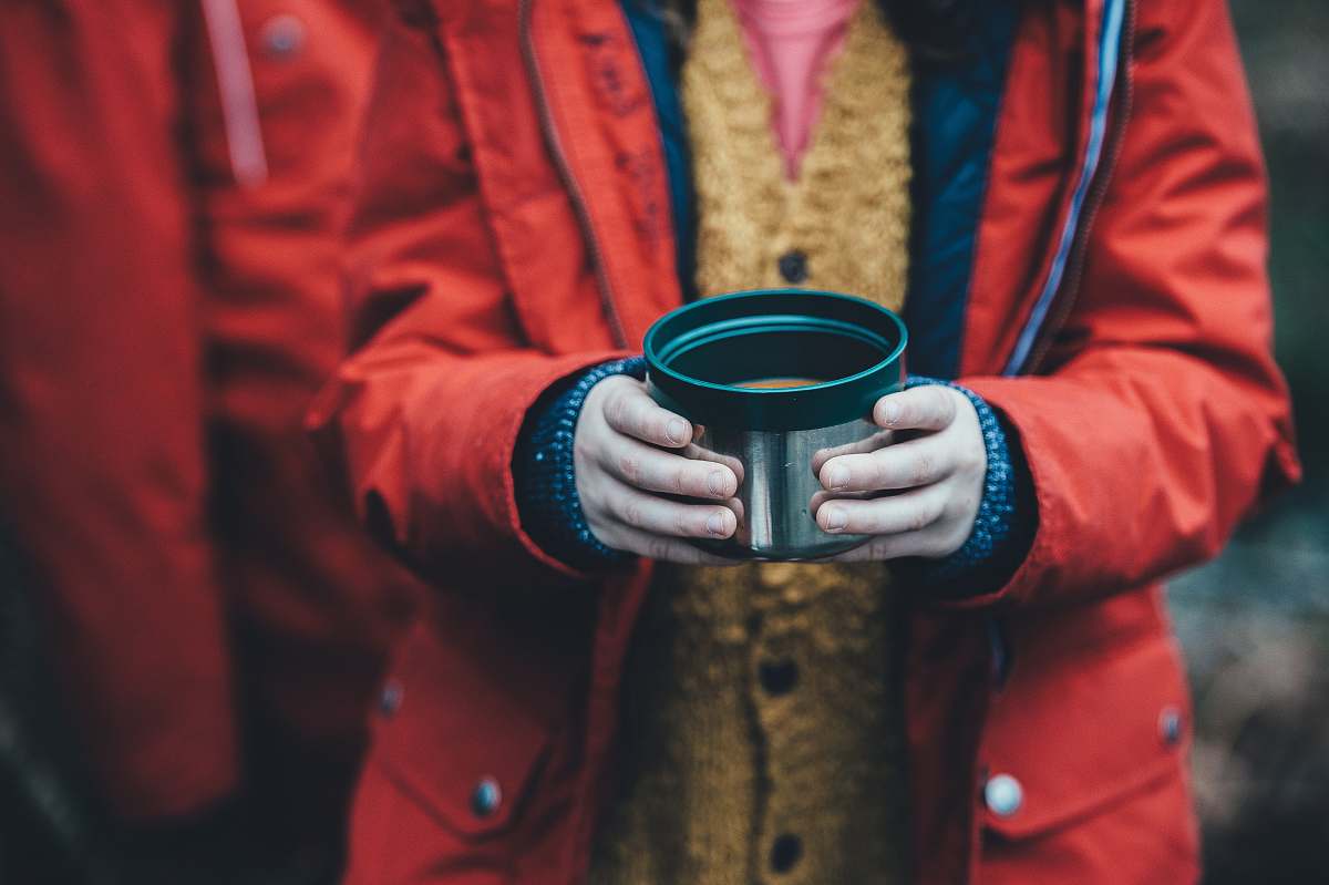 human shallow focus photography of person holding green plastic container person