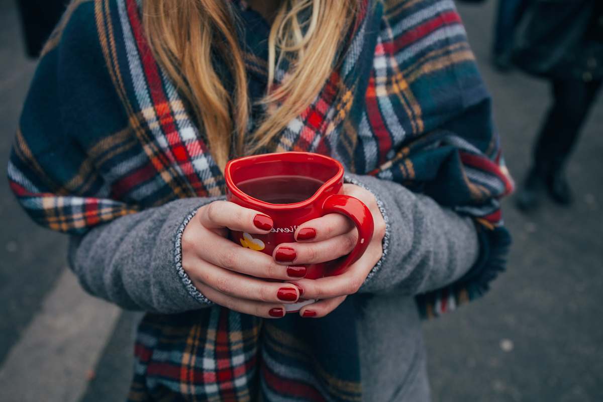 human woman holding a mug mug