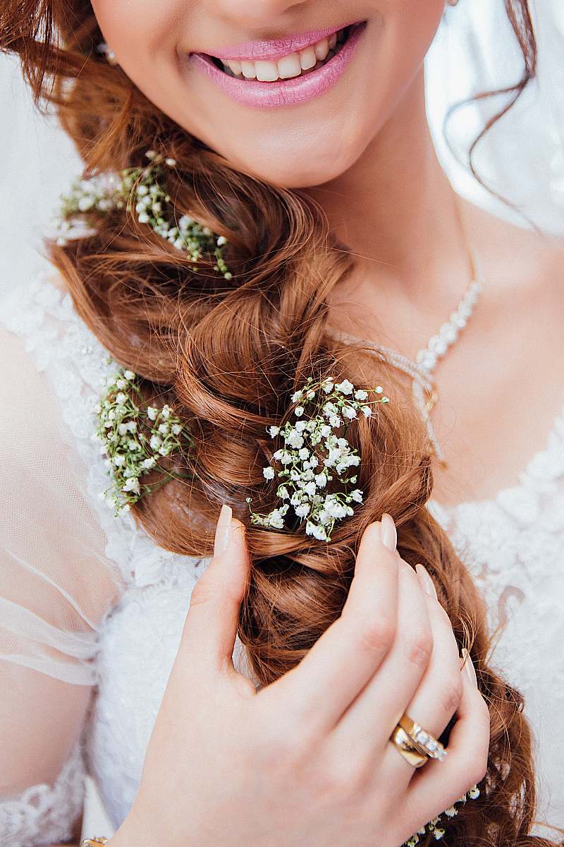 wedding woman holding her hair with flower hair