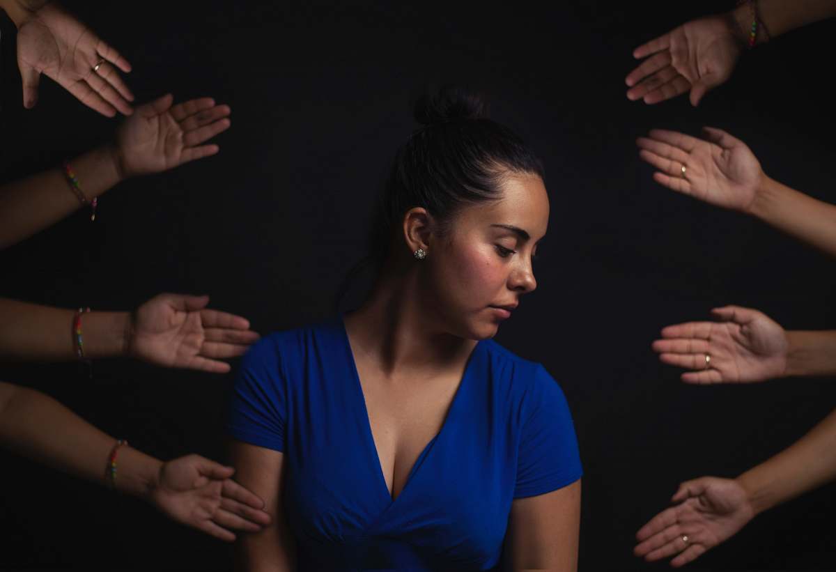 person woman wearing blue V-neck short-sleeved top hands
