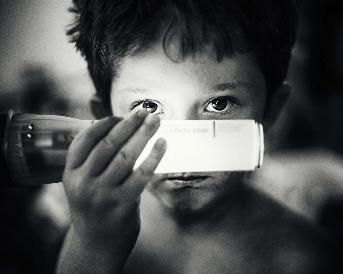 black-and-white grayscale photo of boy holding light bulb people