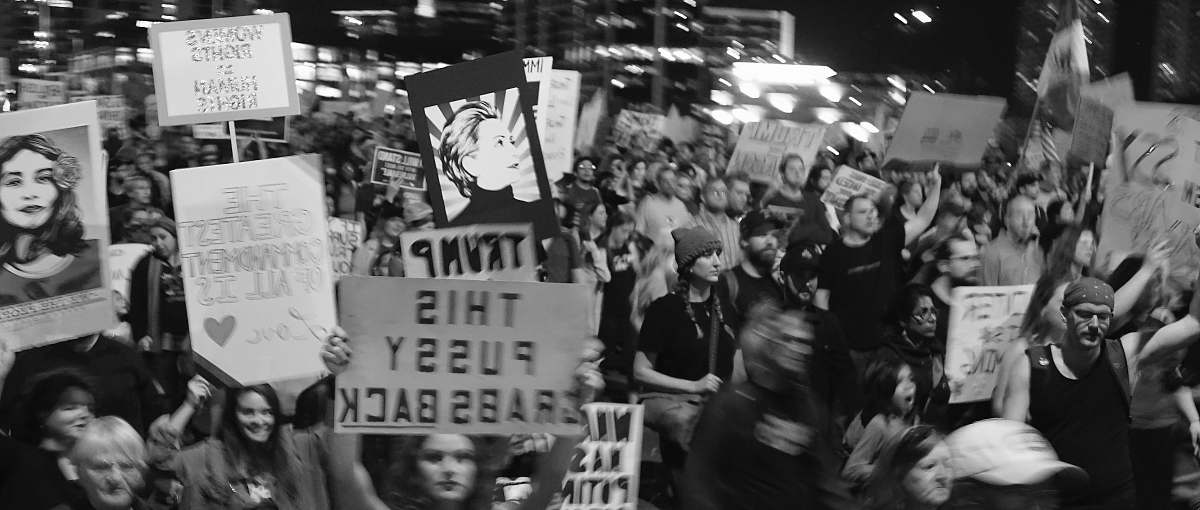 black-and-white grayscale photo of people holding signages crowd