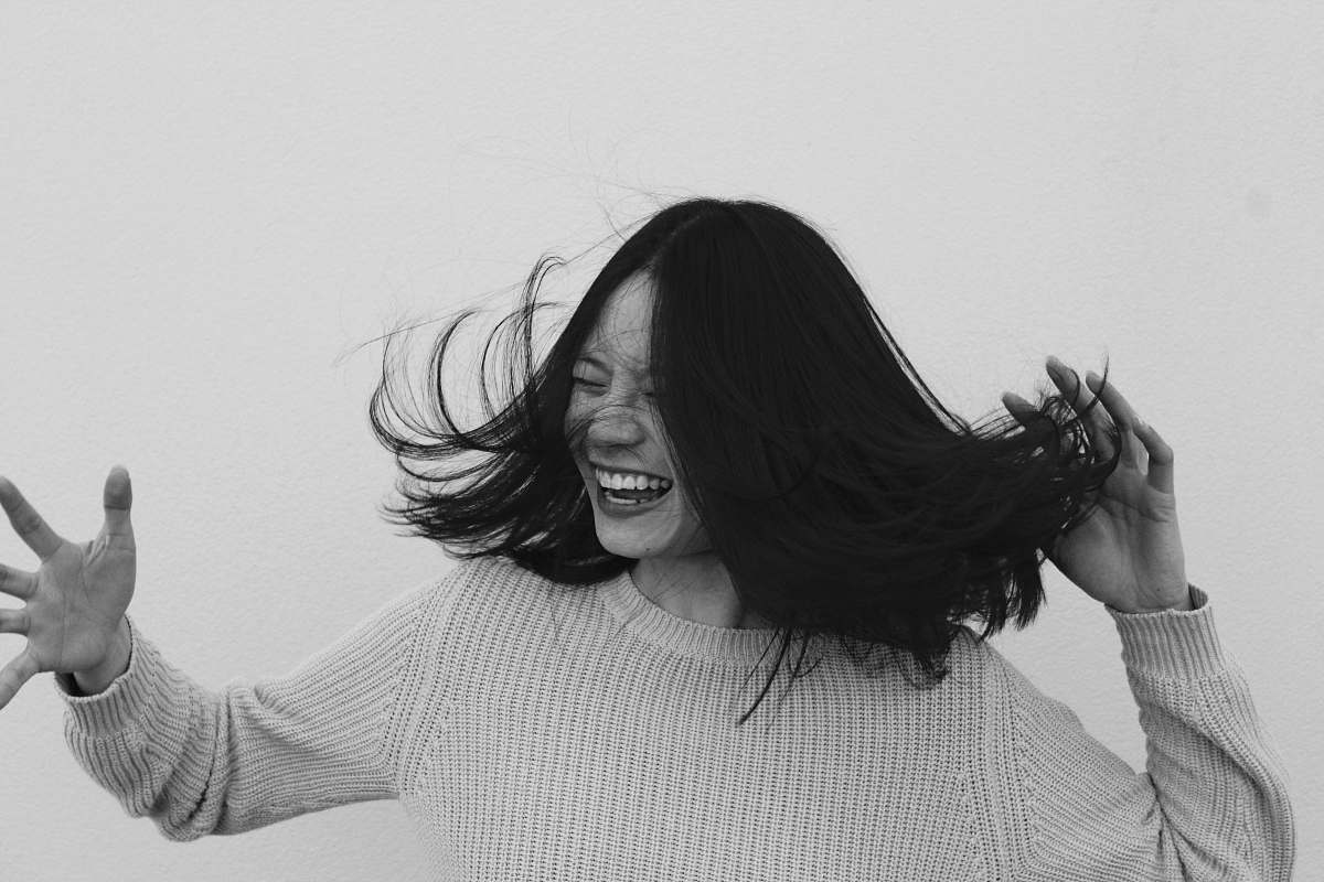 black-and-white grayscale photo of woman flicking hair people