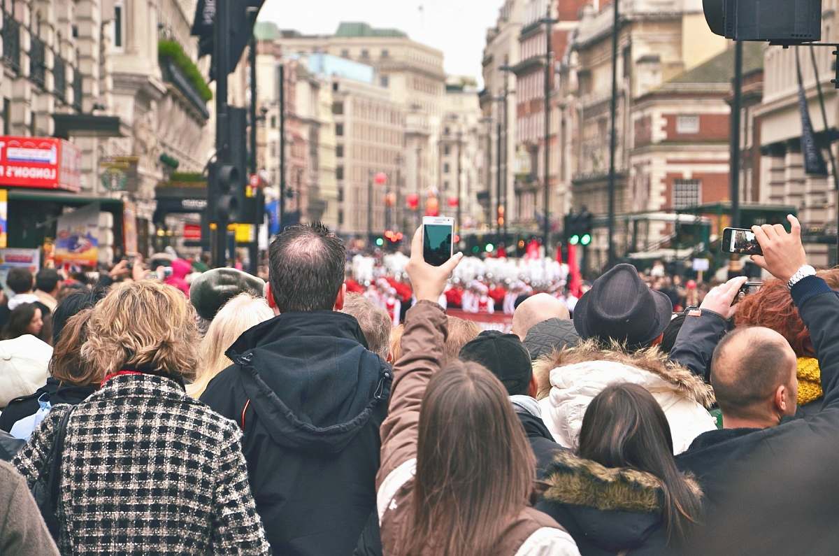 people group of people in street watching parade london