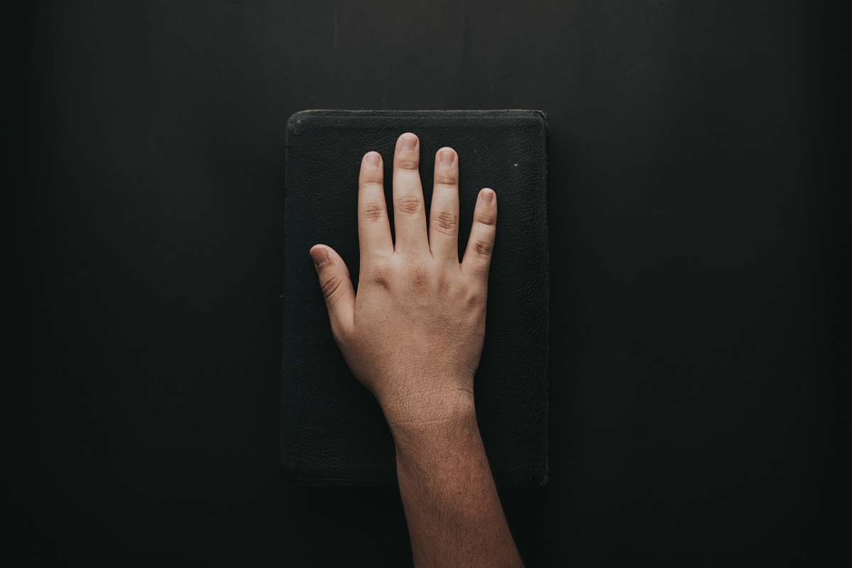 hand left human hand on black book wrist