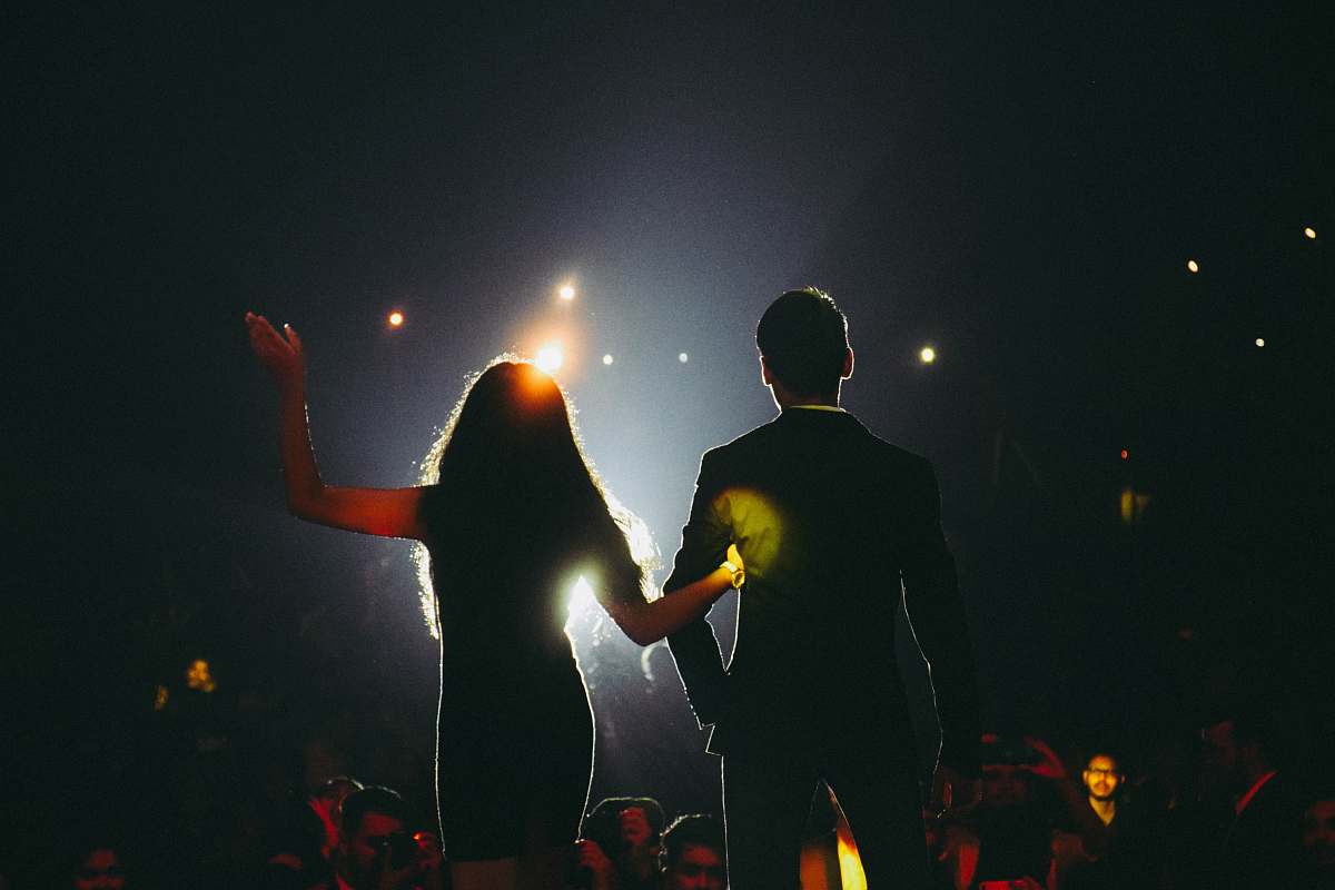 human man and woman on stage flare