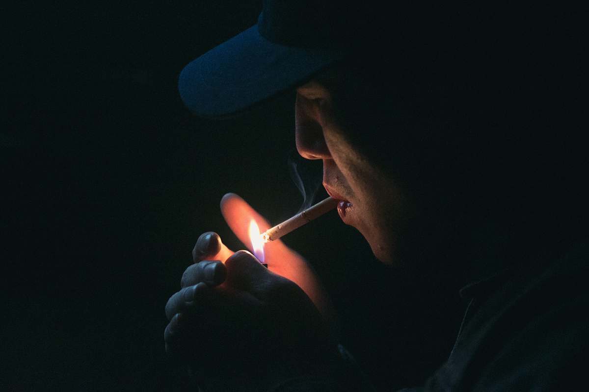 people man lighting his cigarette human