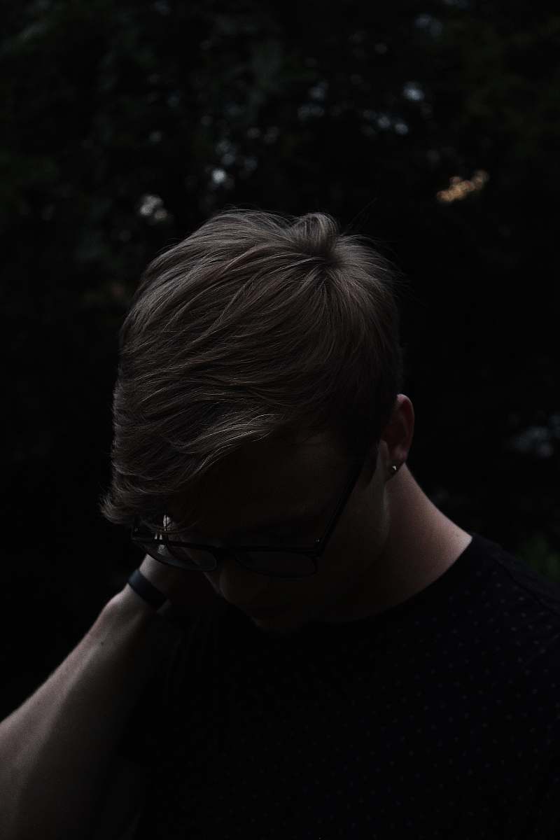 people man wearing black shirt and eyeglasses with left hand on neck human