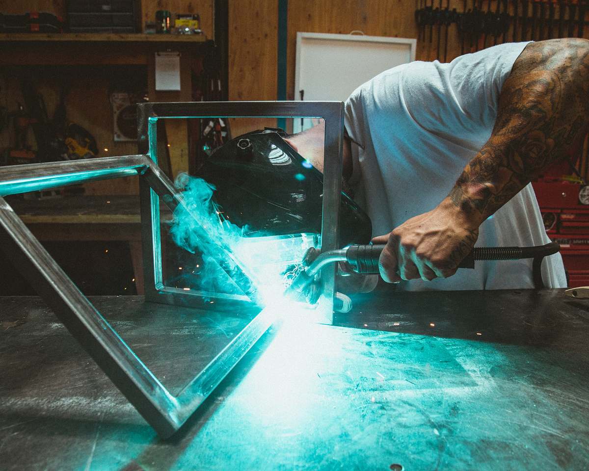 People Man Welding Two Rectangular Gray Metal Frames Human Image Free Photo