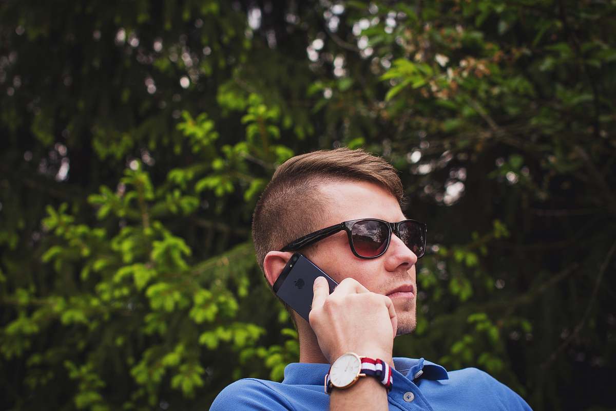 human person holding Android smartphone wearing black sunglasses people