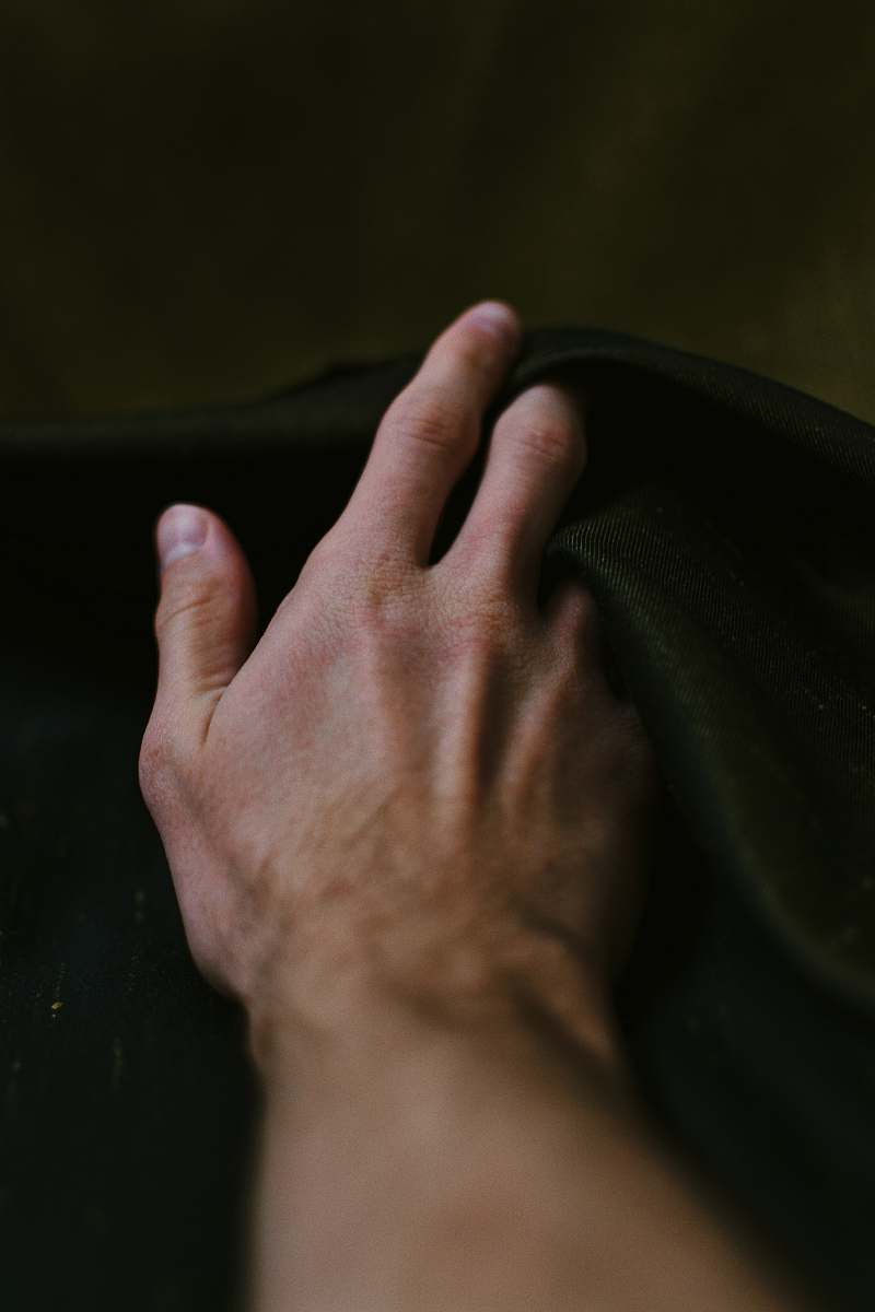 human person holding black textile finger