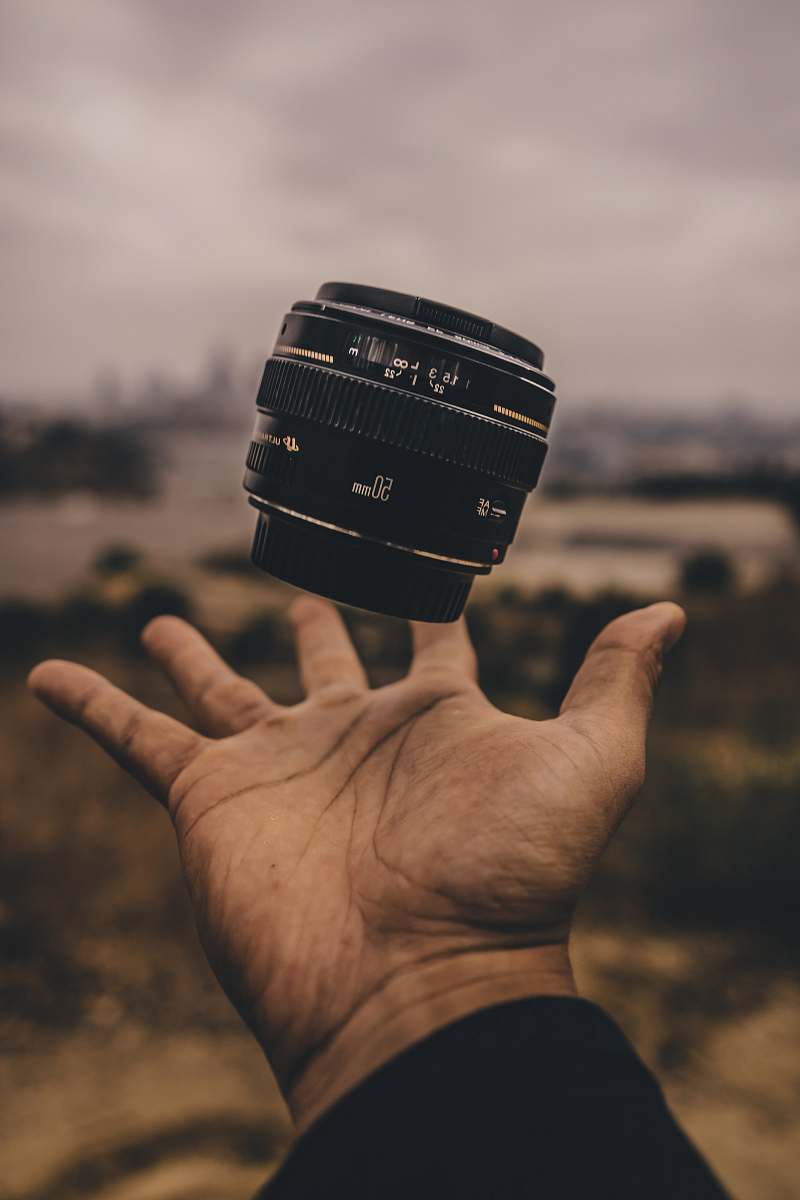 human person holding camera lens people