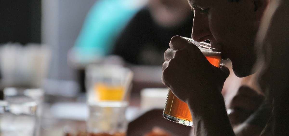beer person holding glass cup while drinking human