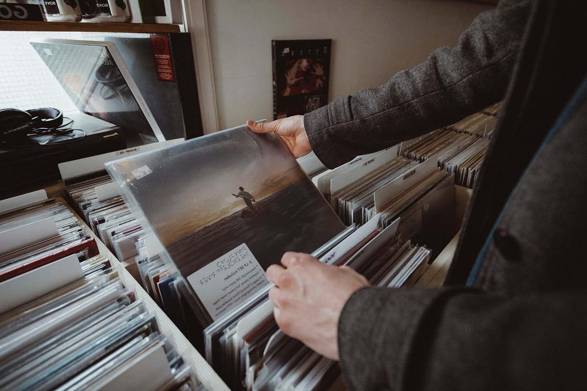 human person holding vinyl album people