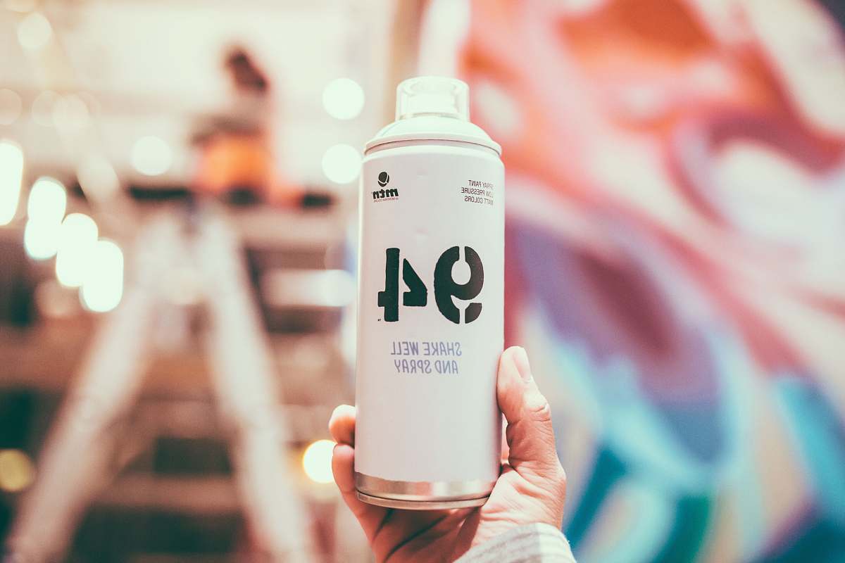 human person holding white spray can people