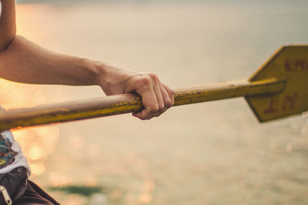 human person holding wooden boat paddle pokhara