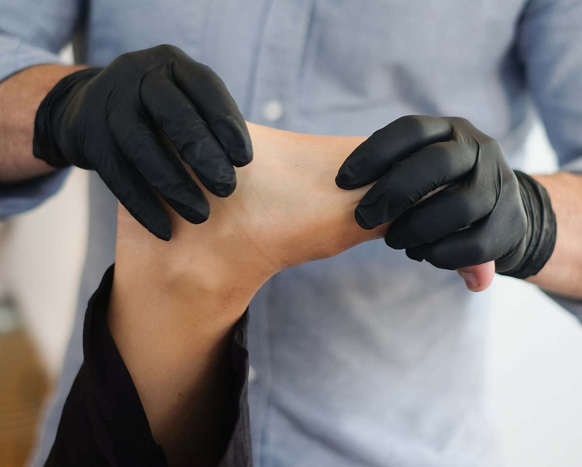 human person massaging other person's foot arm
