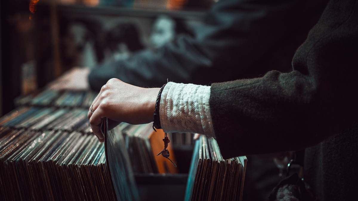 record person picking up the music record music