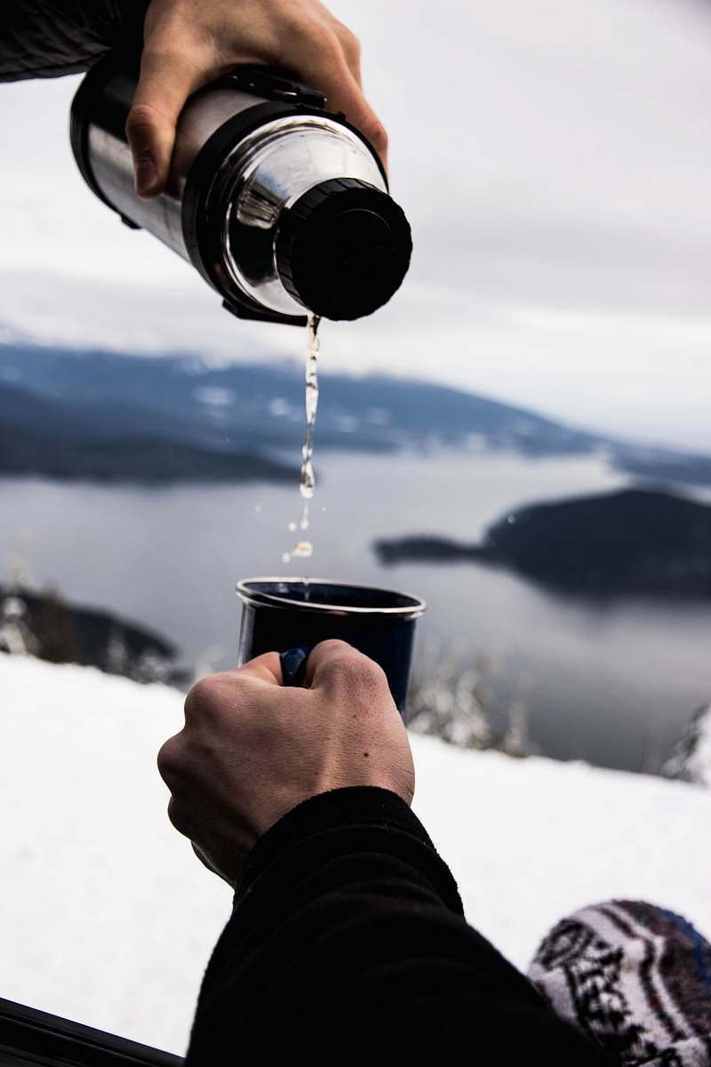 human person pouring water in black ceramic mug people