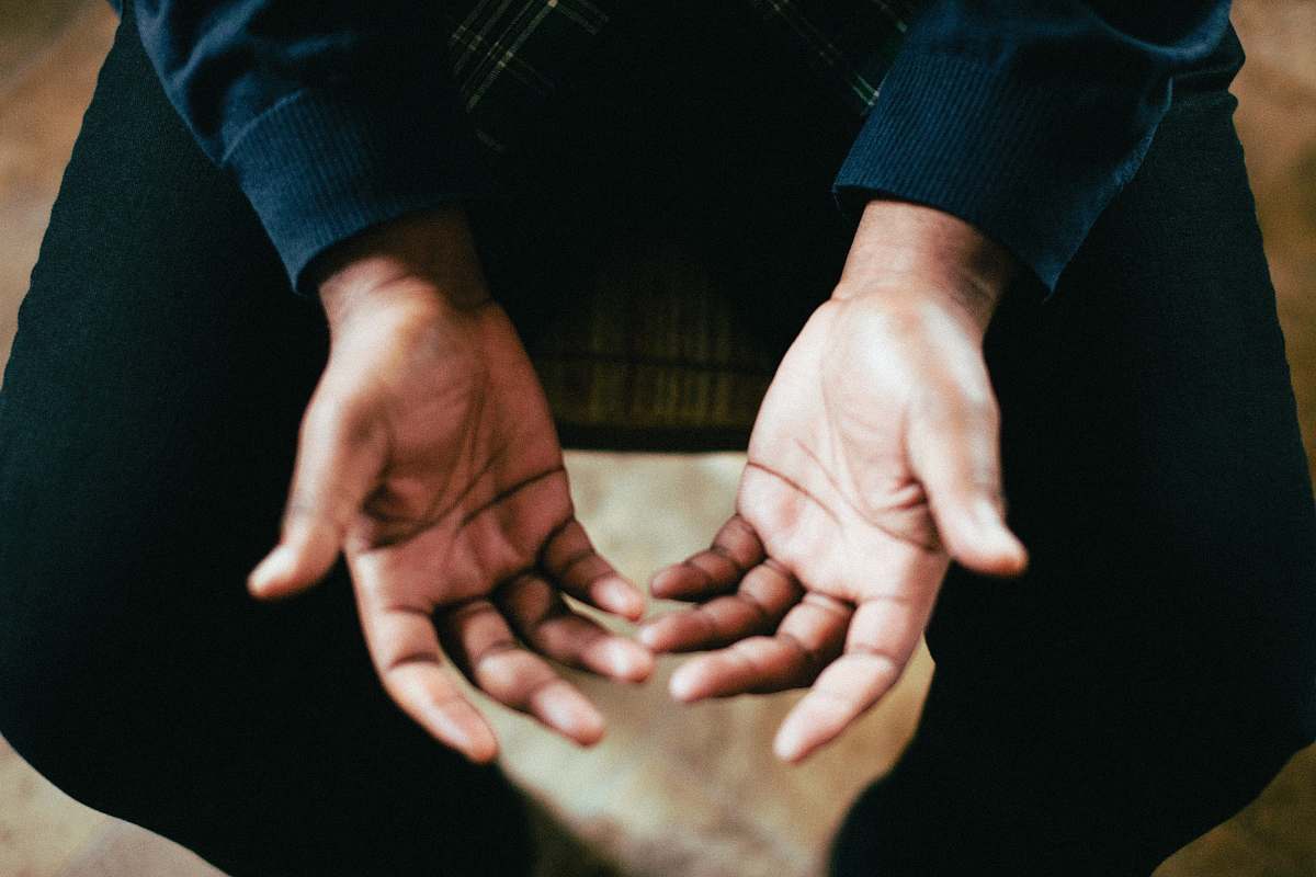 people person showing both palms while sitting on chair hands