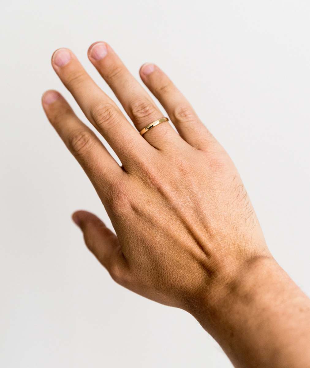human person showing gold-colored ring hand