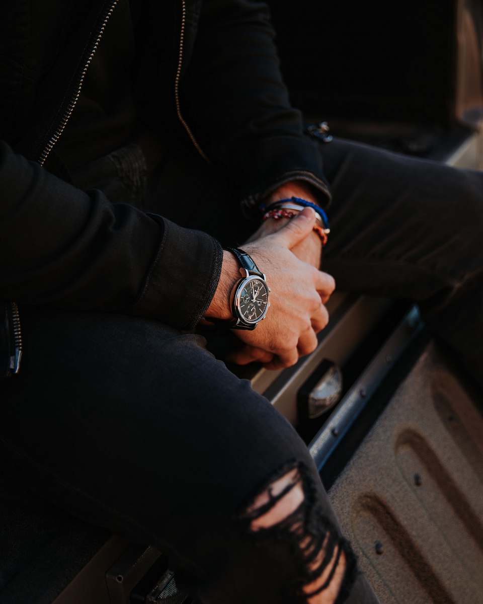 human person sits on truck bed wristwatch
