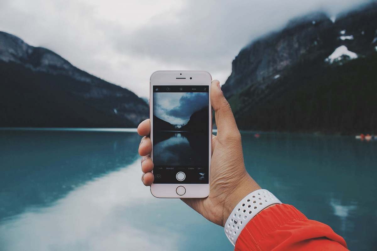 human person taking photo of lake people
