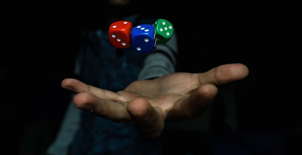 human person throwing three dices hand