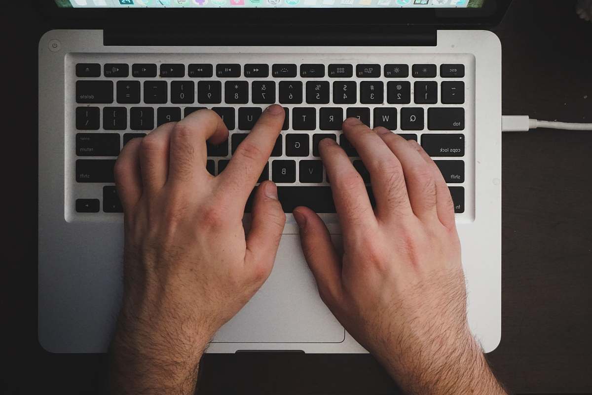 human person using MacBook keyboard